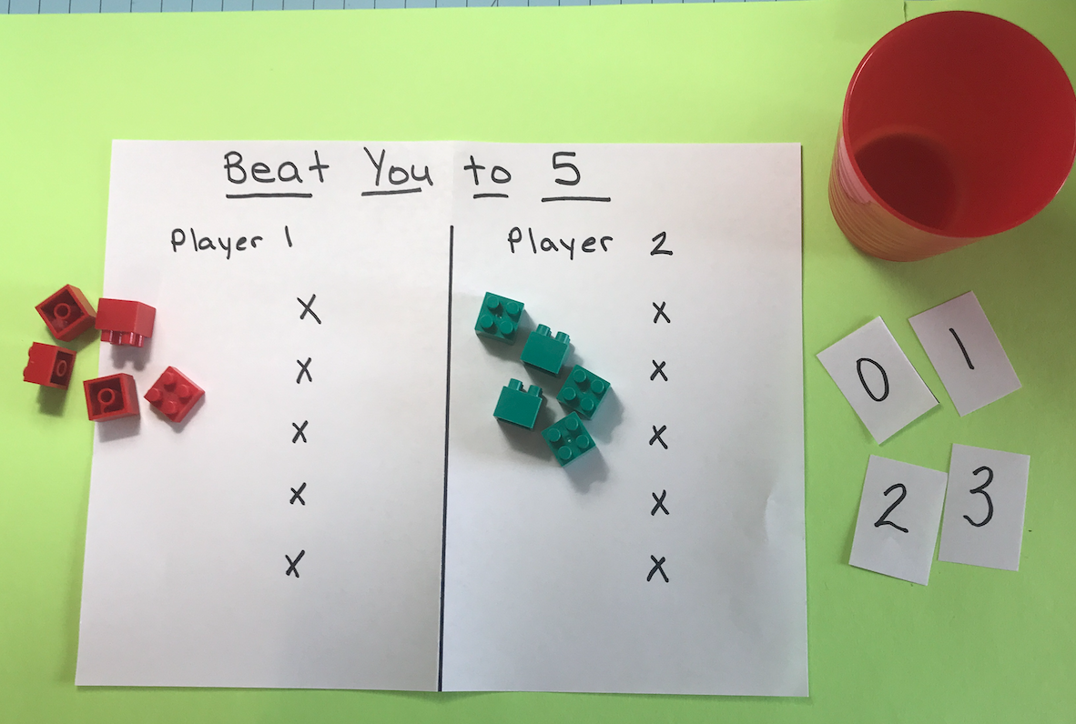 A game sheet labeled, "Beat You to Five," with lego blocks used as counting pieces.
