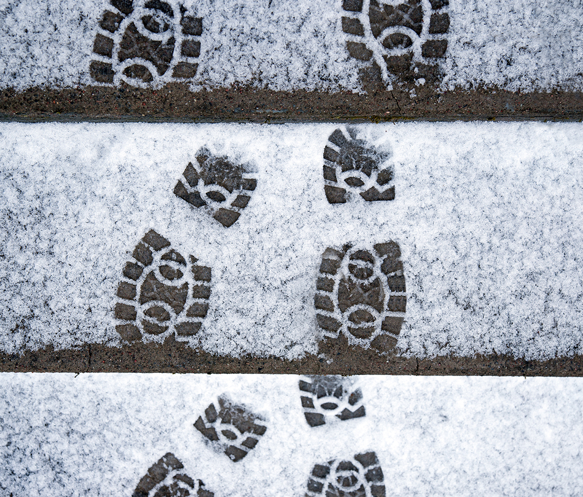 Three sets of boot prints in the snow. One set is just the toe part, one set is full, and one set is just the heel part. The toe part has 3 circles on each boot. The heel par has 1 circle on each boot.