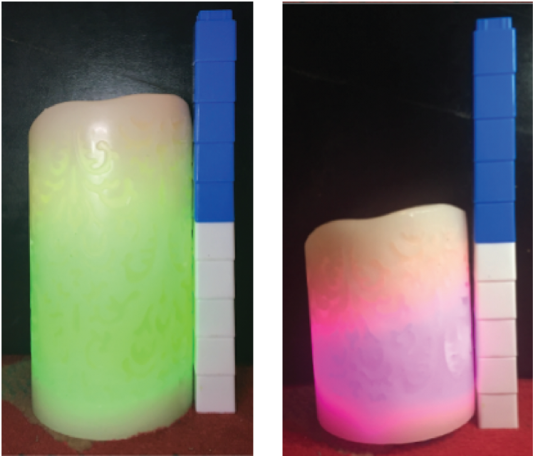 5 white and 5 blue cubes are stacked next to a green candle. The candle is 2 cubes shorter than the stack. 5 white and 5 blue cubes are stacked next to a pink candle. The candle is 4 cubes shorter than the stack.