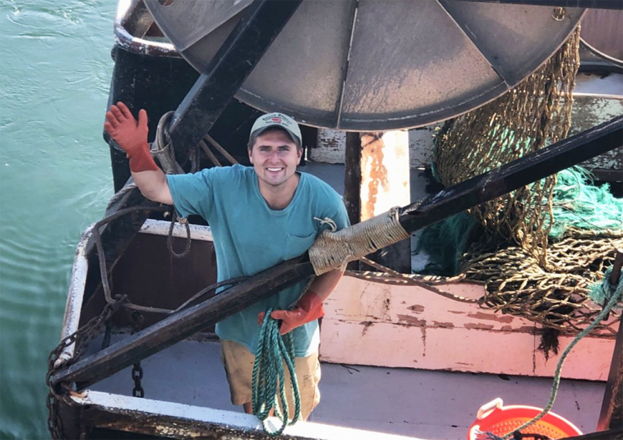 Fisherman waving from his boat.