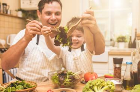 Tyler and his dad make salad together.